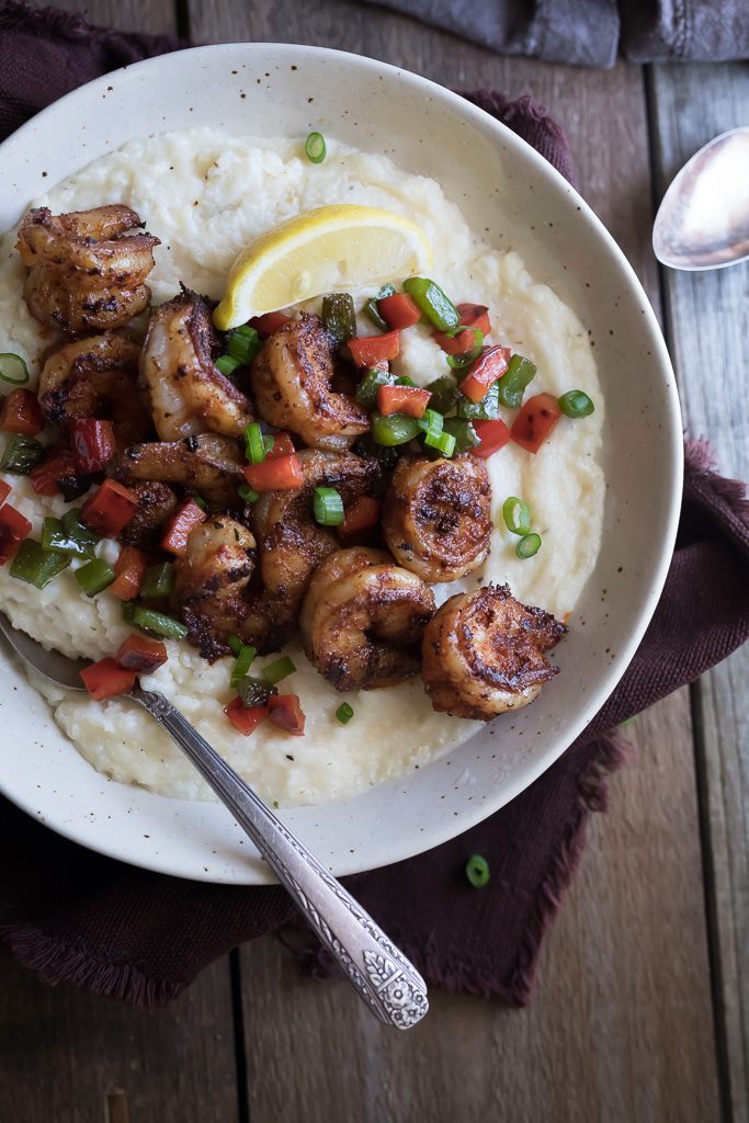 Cajun Shrimp and Grits ready and served in a big bowl with a spoon inside