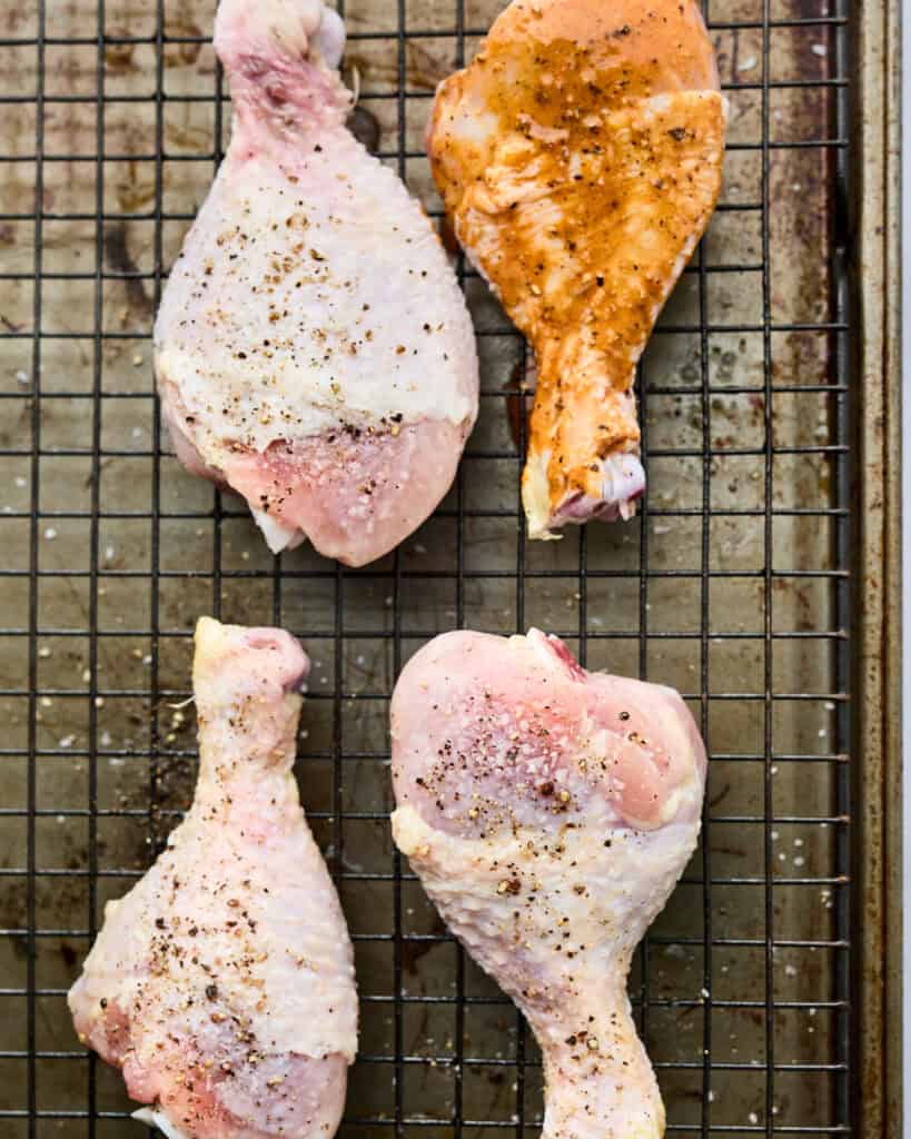 Chicken on pan seasoned and coated with BBQ sauce ready to cook. 