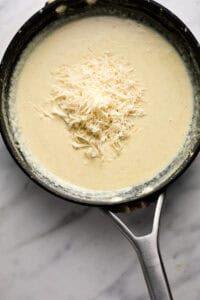 Pan of cream sauce with cheese cooking