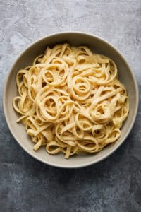 Bowl of cooked pasta and cream sauce