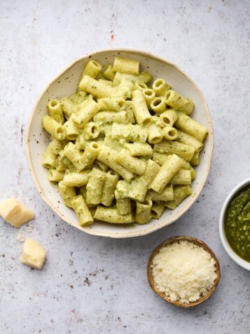 Bowls of pesto pasta pesto and cheese