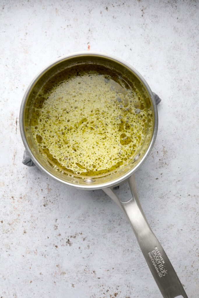 Pesto heavy cream sauce in small pan