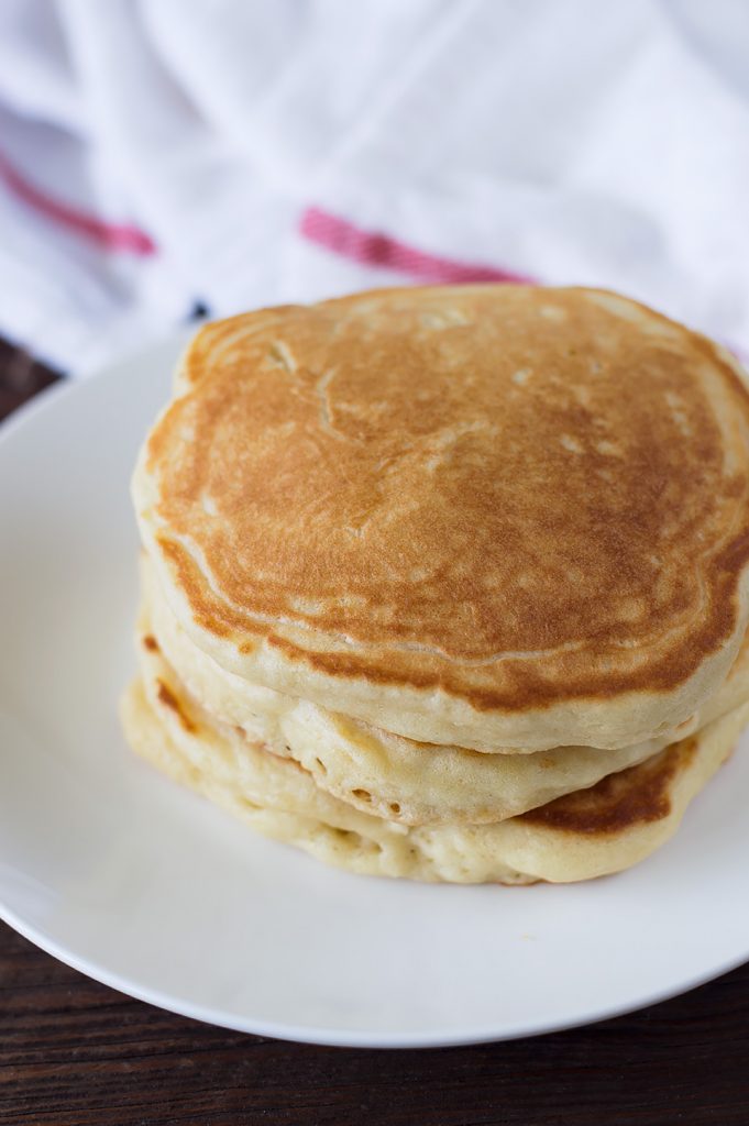 A batch of fluffy pancakes before being glazed with strawberries