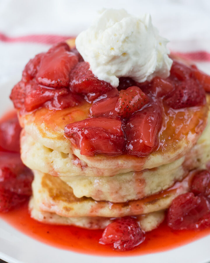 Pancakes with Strawberry Glaze served in a white plate