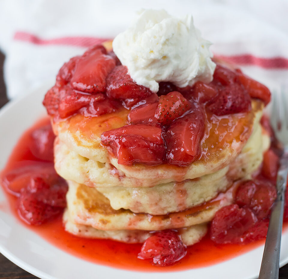 Pancakes with Strawberry Glaze served in a white plate