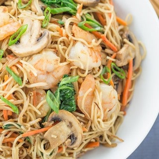 Easy Stir Fried Chinese Noodles with Shrimp in a white bowl with chopsticks on the side