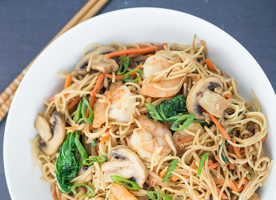 Closeup of the easy Stir Fried Chinese Noodles with Shrimp on a dark blue surface