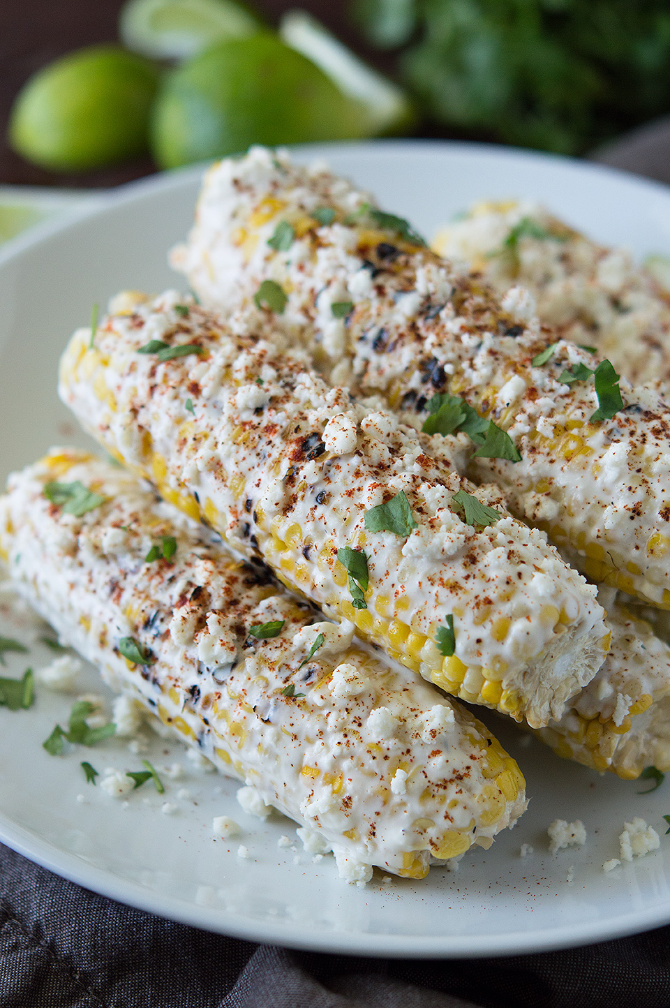 Closeup on the homemade Mexican Street Corn, Elotes, looking extra inviting in a big white plate