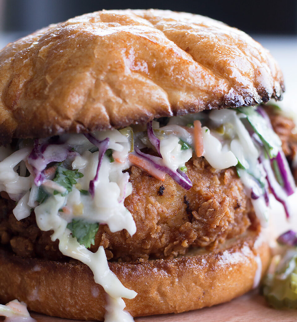 Closeup of the delicious Buttermilk Fried Chicken Sandwich with Cilantro Jalapeño Coleslaw