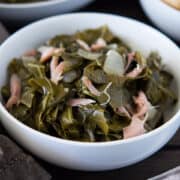 Cooked slow cooker greens in white bowls