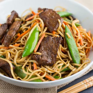 Stir Fried Thai Red Curry Noodles with Beef served with chopsticks