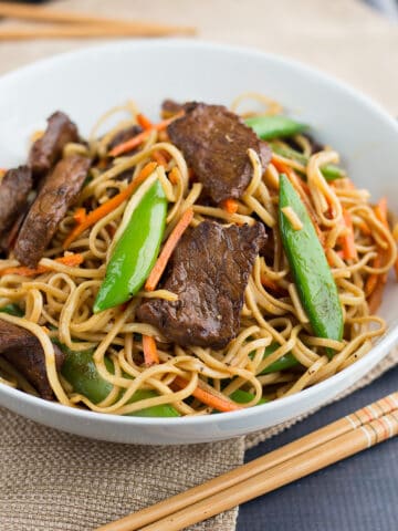 Stir Fried Thai Red Curry Noodles with Beef served with chopsticks