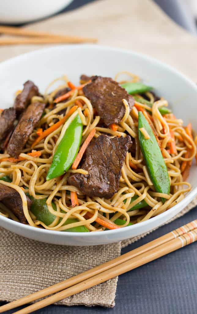 Stir Fried Thai Red Curry Noodles with Beef served with chopsticks