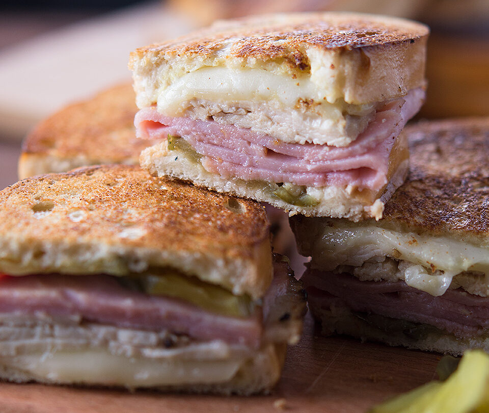 turkey cuban sandwiches on wooden board