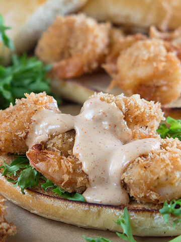 Cajun Panko Crusted Shrimp Po Boys served with greens and tomatoes