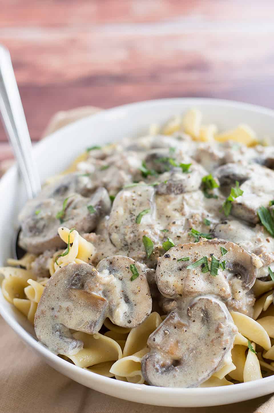 Easy Ground Beef Stroganoff served with a fork in a big white bowl