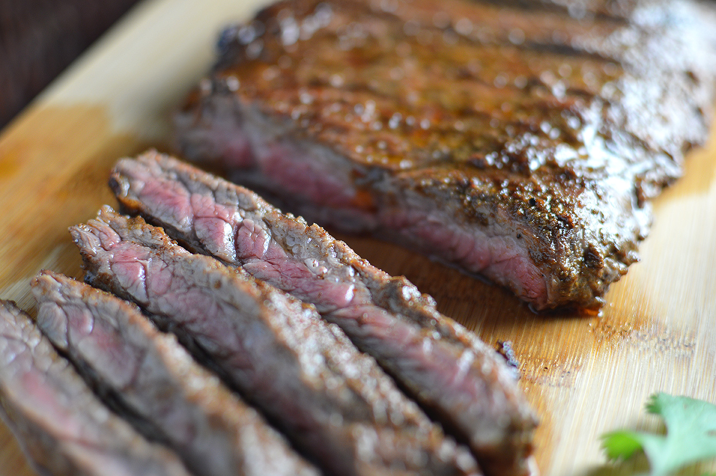 Closeup on the delicious Citrus Marinated Skirt Steaks served on a wooden board