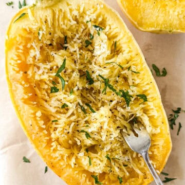 Cooked Garlic Parmesan Spaghetti Squash on parchment paper