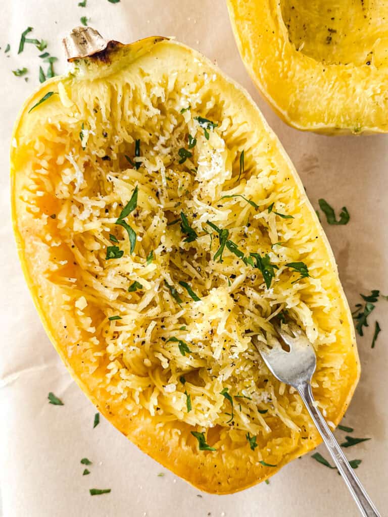 Cooked Garlic Parmesan Spaghetti Squash on parchment paper