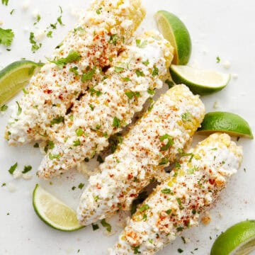Corn with limes on white top