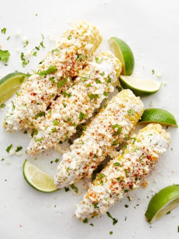 Corn with limes on white top