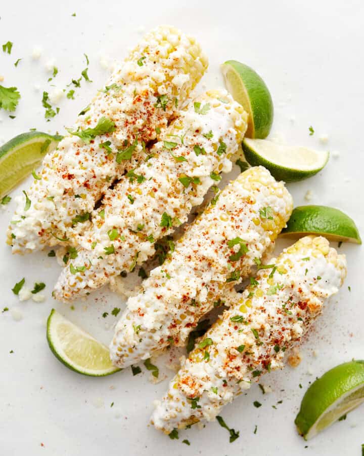 Corn with limes on white top