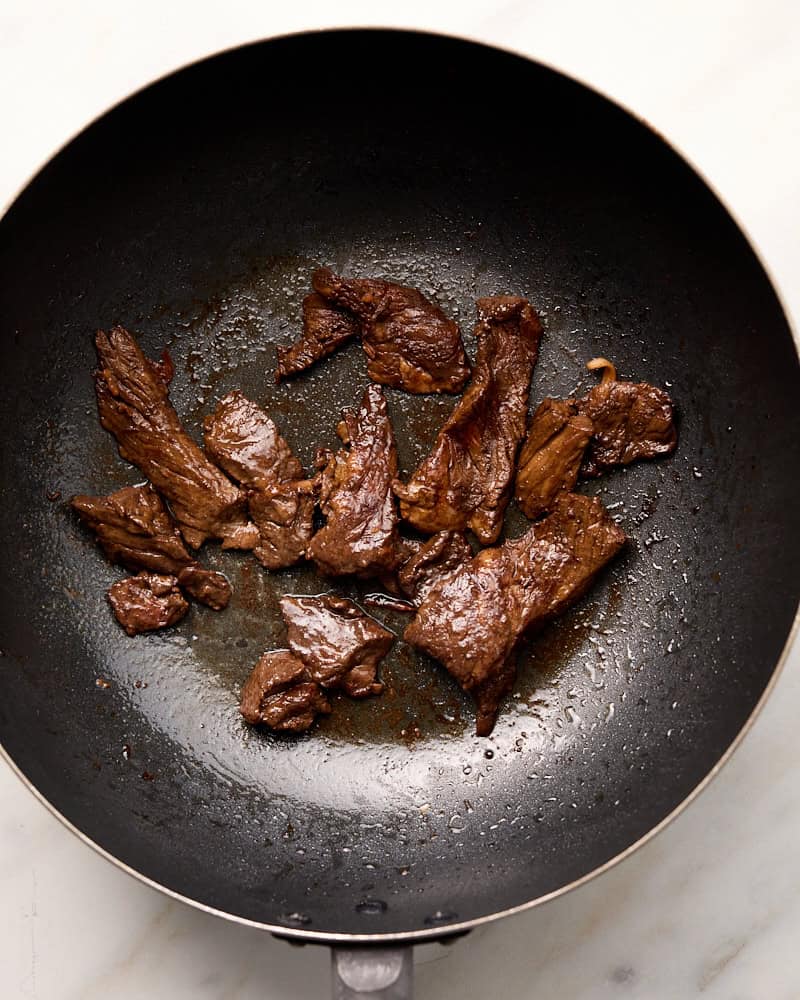 Cooked sliced beef in wok. 