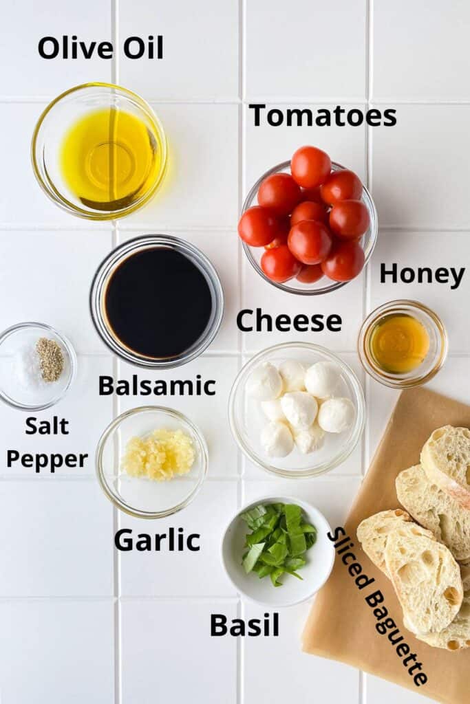 Recipe ingredients in glass bowls and on brown paper on white table top.