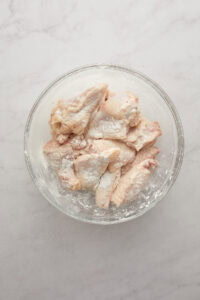 Seasoned wings in a glass bowl