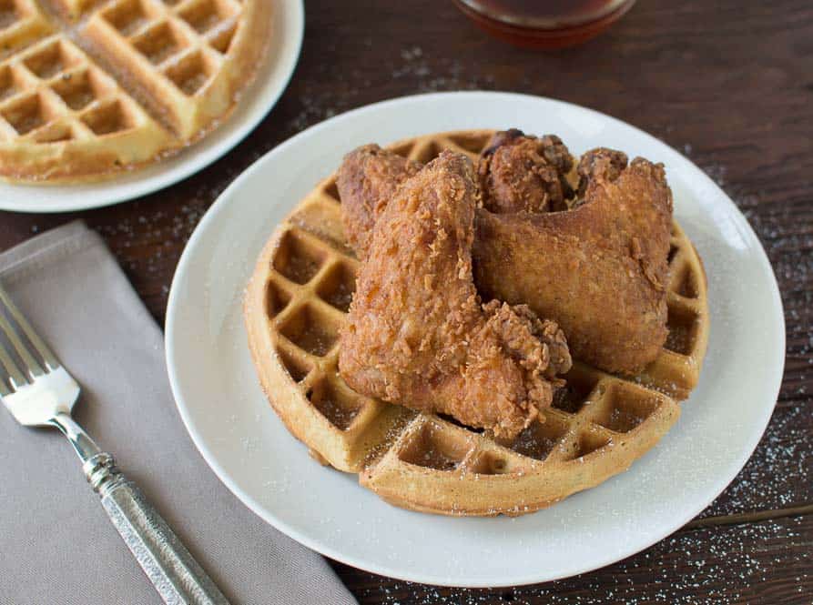 Buttermilk Fried Chicken served with Buttermilk Peach Waffles and a metal fork on the side