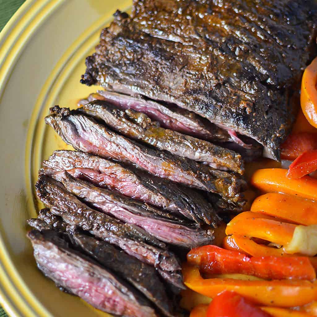 citrus marinated steak on plate with peppers
