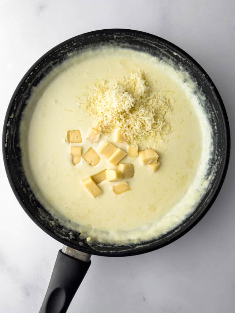 Havarti sauce cooking in pan with added cheese