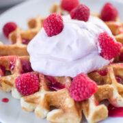 Buttermilk Waffles with Raspberry Champagne Mascarpone Cream served on a white plate