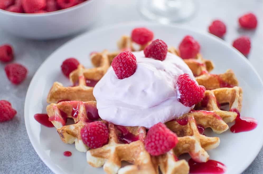 Closeup of the mouthwatering Buttermilk Waffles with Raspberry Champagne Mascarpone Cream