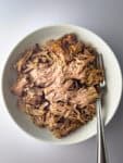 slow cooker kalua pork in white bowl