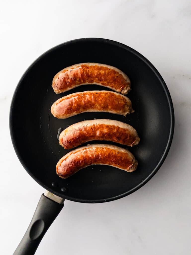 Cooked Italian sausage links in pan