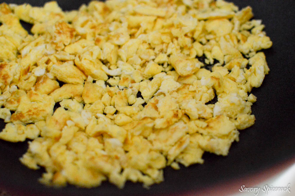 Closeup of the delicious scrambled eggs in a big pan.