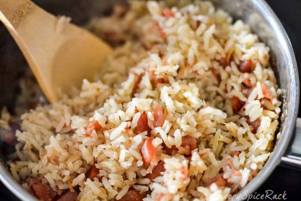 Cooked Mexican Rice in pot with spoon.