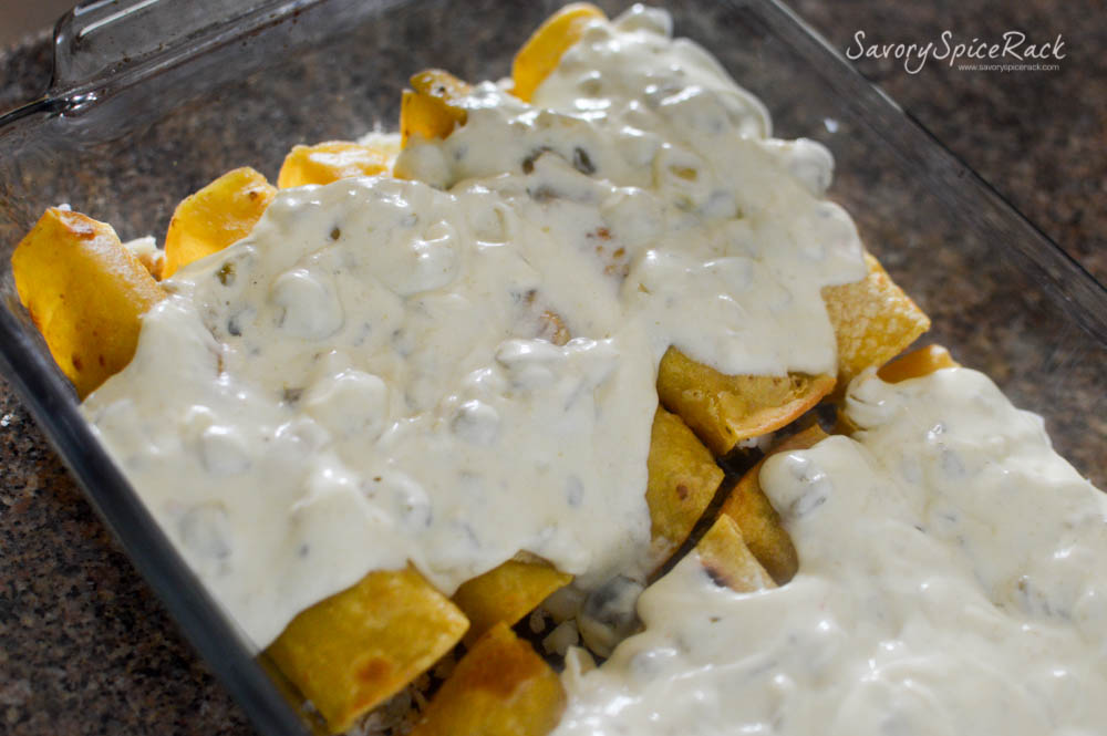 Pouring White Sauce over Enchiladas