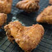 Buttermilk Fried Chicken on an oven rack looking extra crispy and delicious