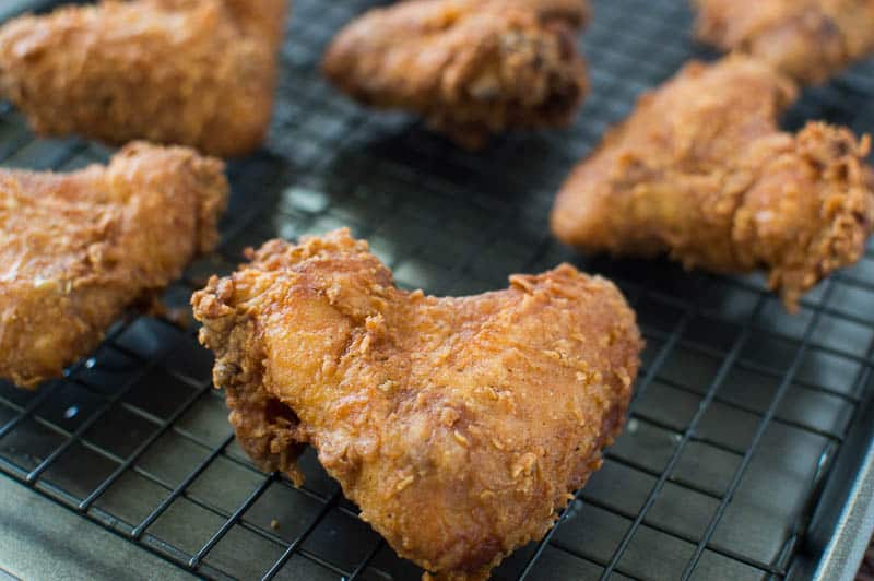 Buttermilk Fried Chicken on an oven rack looking extra crispy and delicious